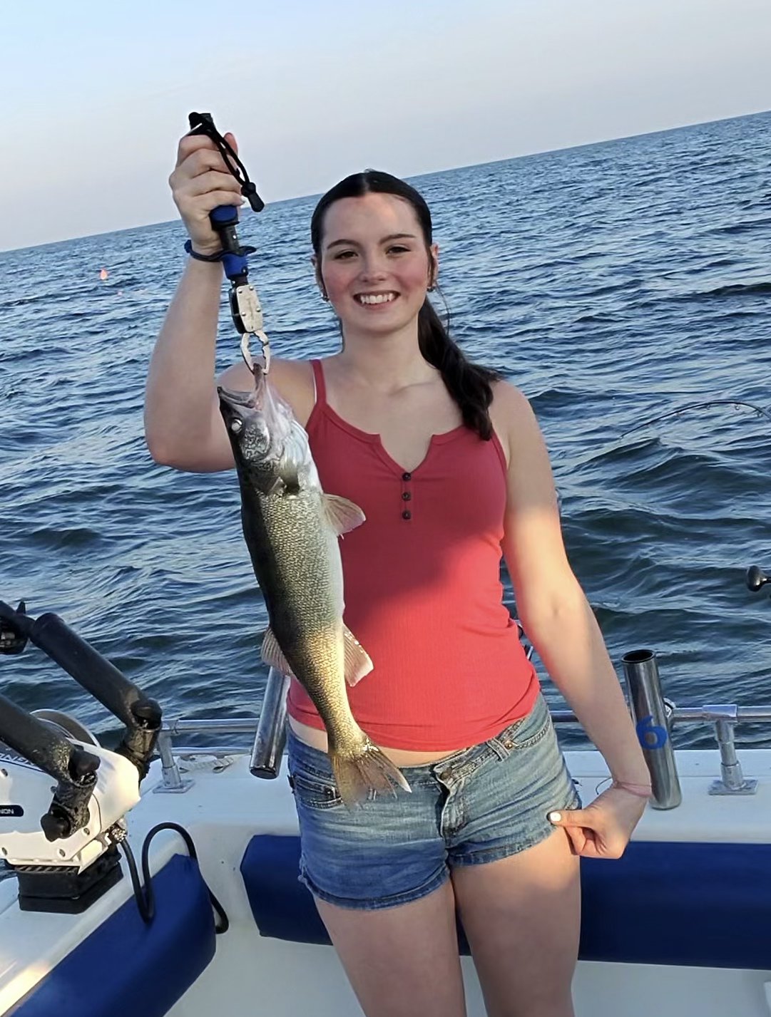 Sir Walleye Charters client with a Lake Erie walleye at sunset on the Central Basin