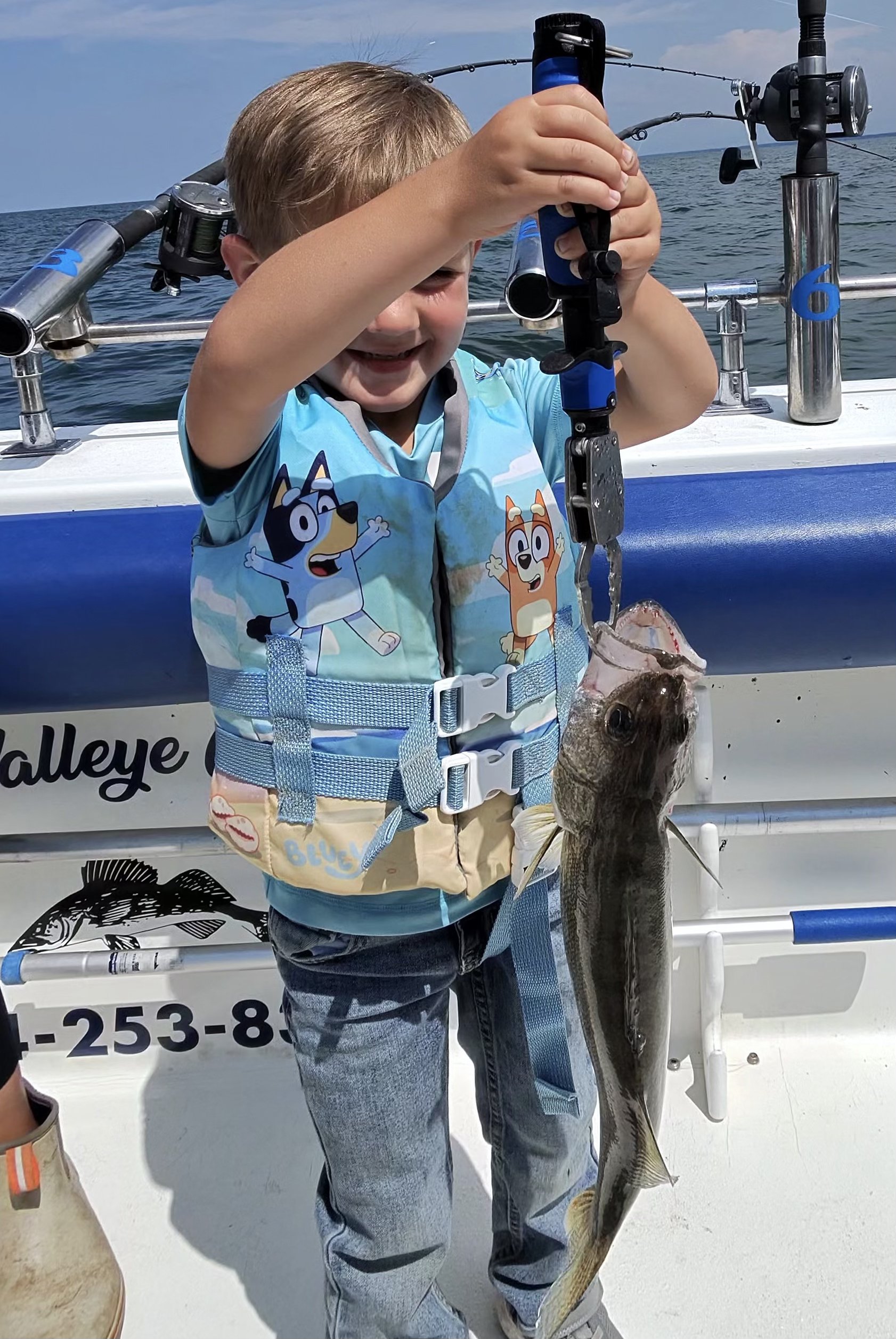Young Sir Walleye Charters client proudly holding up his very first Lake Erie walleye - kids welcome