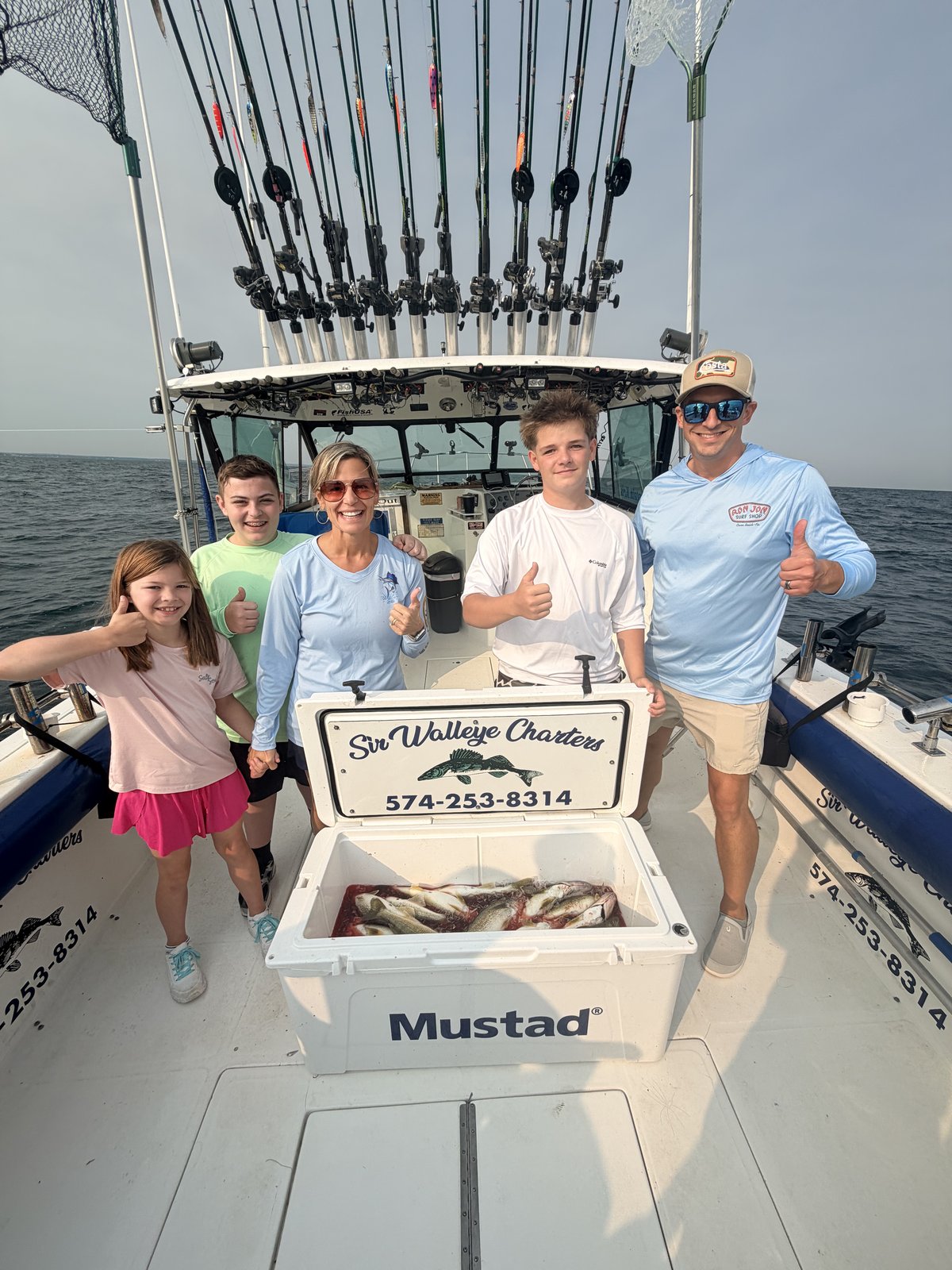 Family of Sir Walleye Charters clients with a full cooler of Lake Erie walleye - July 21 2026