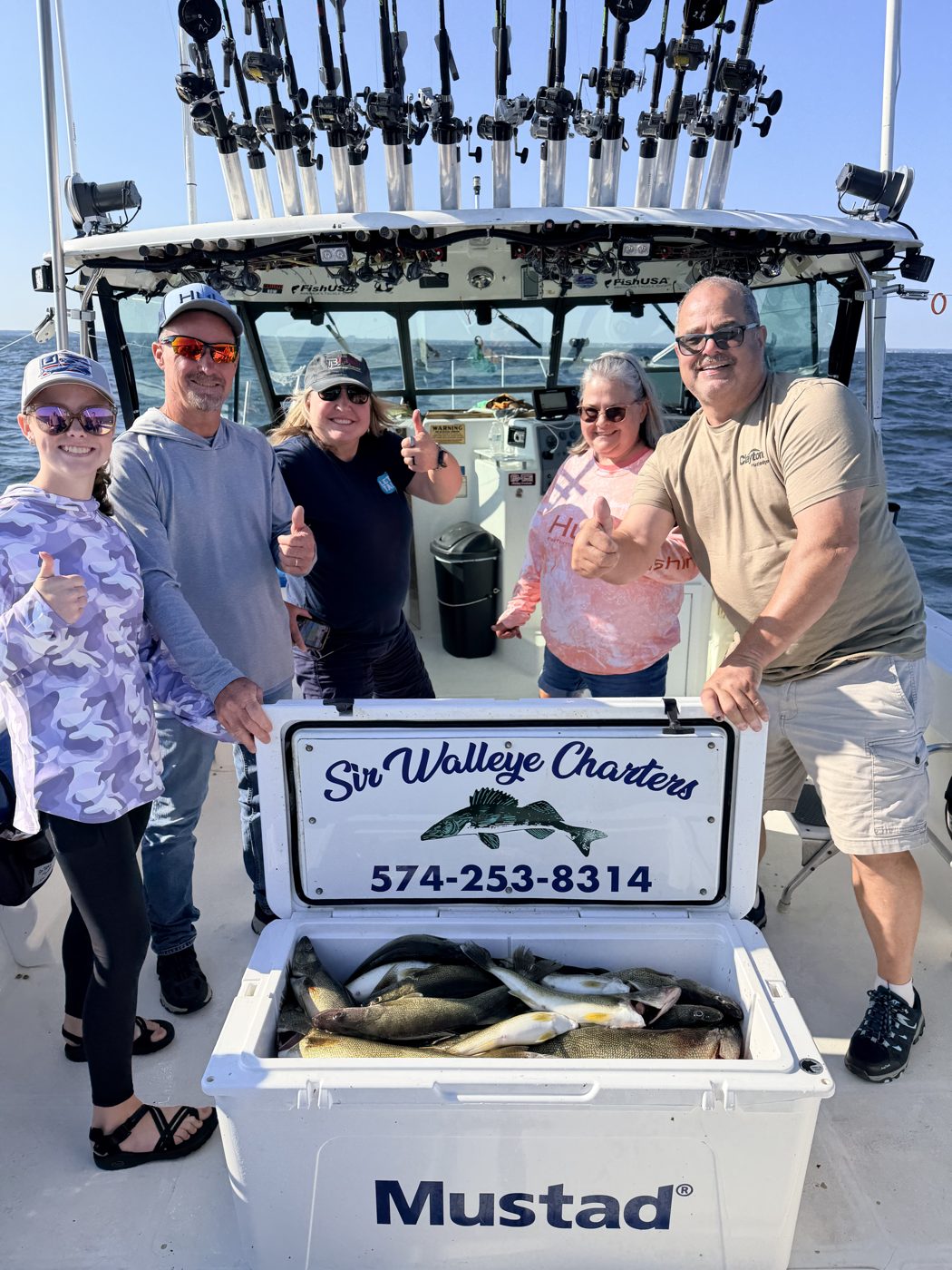 Sir Walleye Charters group with a limit of Lake Erie walleye in the branded cooler - Central Basin out of Lorain, August 2026