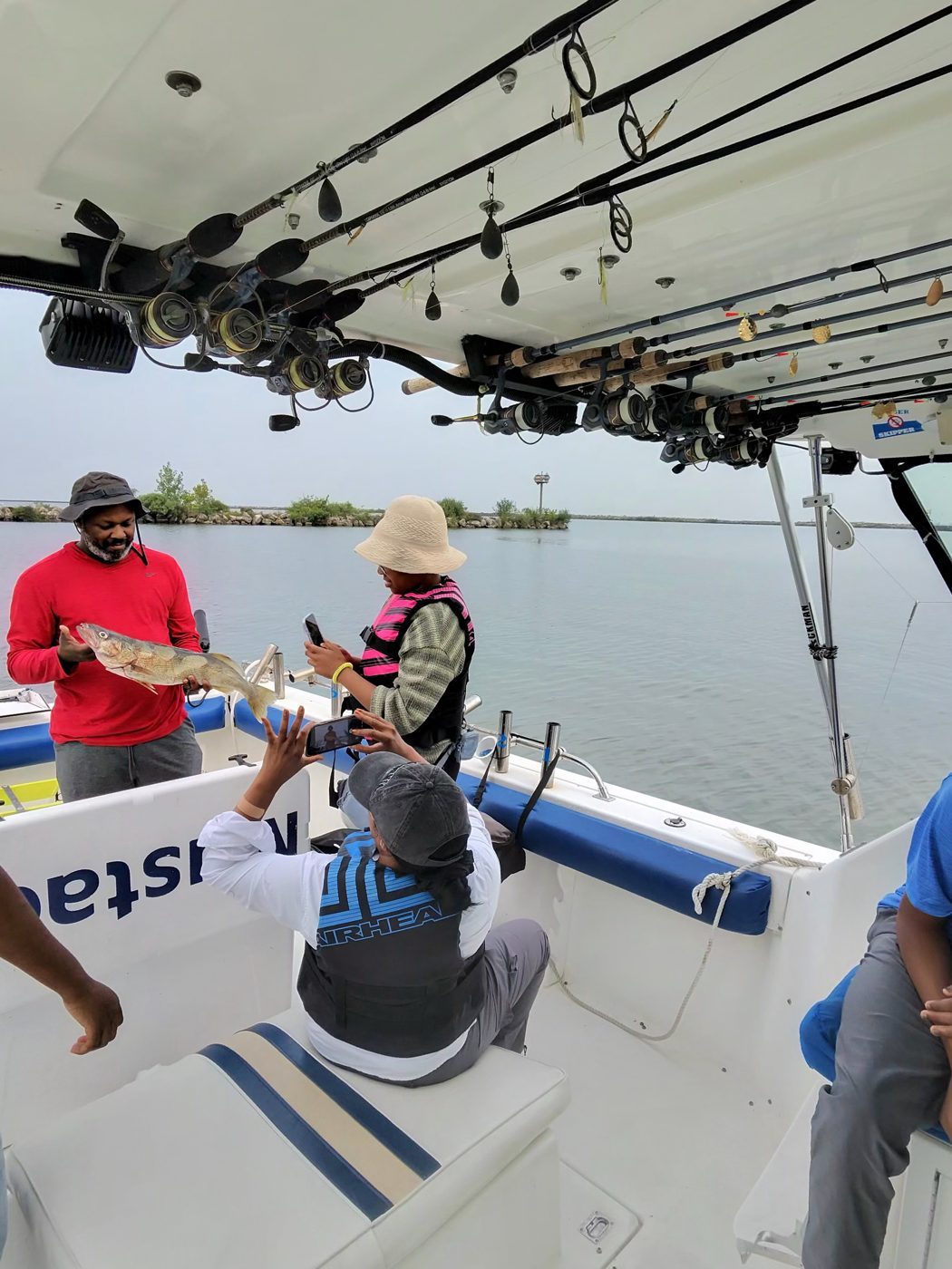 Anglers landing a Lake Erie walleye on a Sir Walleye Charters trip out of Lorain, Ohio