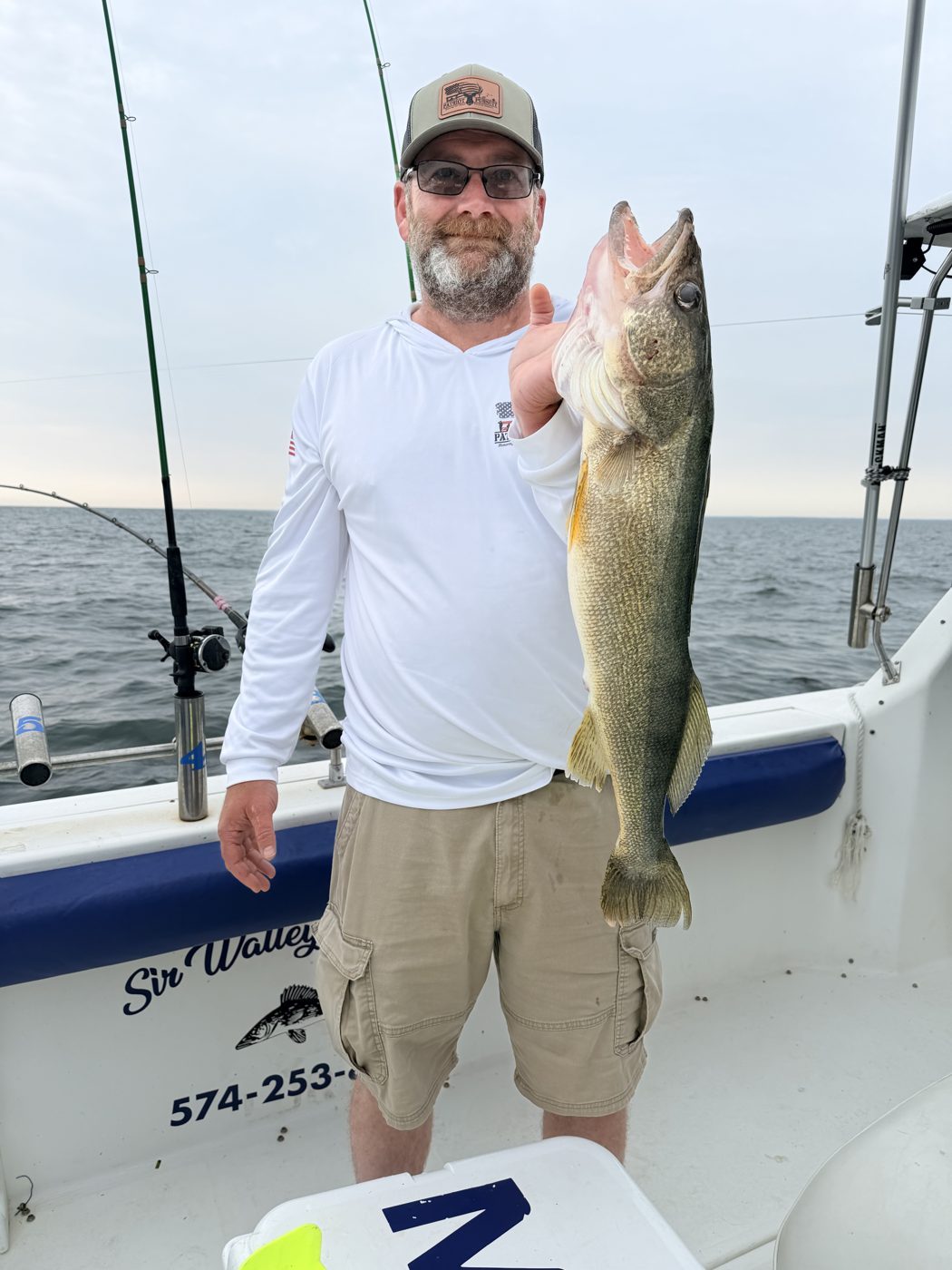 Angler with a nice Lake Erie walleye at last light aboard Sir Walleye Charters out of Lorain