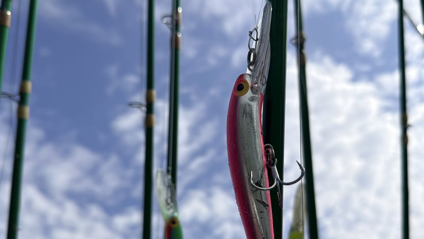 Pink-and-chrome deep Thunderstick trolling lure in the rod rack aboard Sir Walleye Charters on Lake Erie