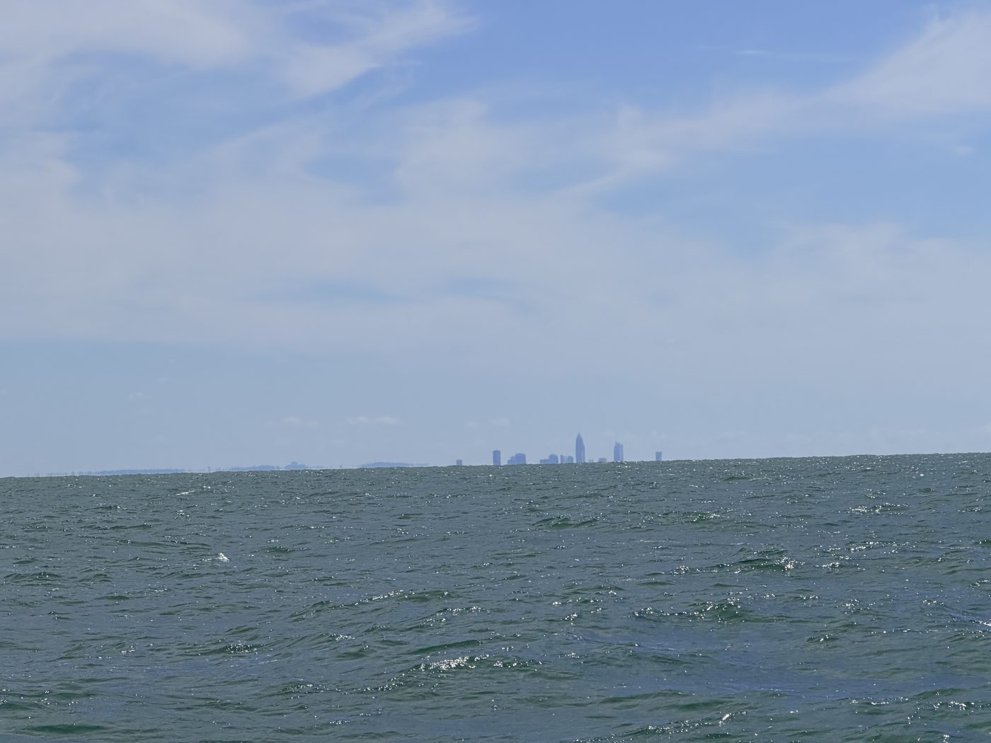 The Cleveland skyline on the horizon from far offshore on Lake Erie during a long run to Central Basin walleye water with Sir Walleye Charters