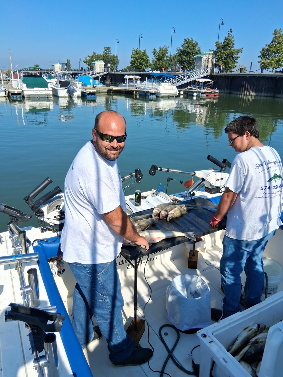 Captain Kris and crew cleaning the day's walleye catch dockside
